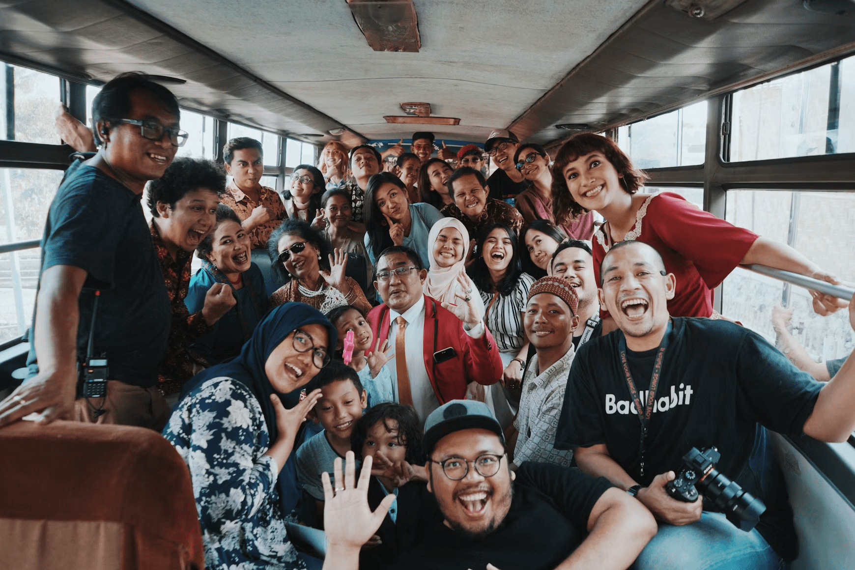 Indonesian learners packed into a bus, laughing together